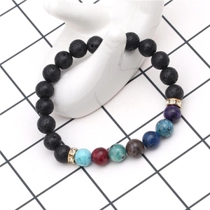 Lava stone bead bracelet with turquoise and rhinestone spacers on a white hand model
