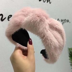 Pink faux rabbit fur headband with knot design and soft plush texture for winter