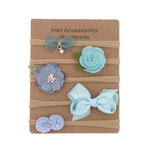 Detail of 5-piece floral nylon headbands and bow clips set on a display card