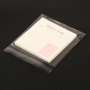 Detail view of Weekly Plan notepad in ivory white with clear protective packaging