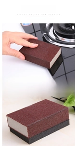 Detail of dual-layer emery sponge showing the coarse brown abrasive and soft foam layers