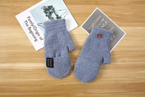 Detailed view of blue-gray knit gloves with convertible flip-top and button closure