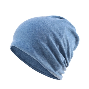 Macro shot of the blue knitted beanie hat showing soft fabric texture and stitching details
