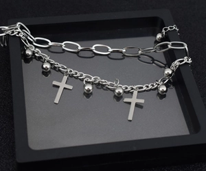 Close-up of silver double-layer stainless steel bracelet with cross charms and beads