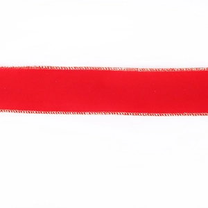 Macro detail of red velvet Christmas ribbon with gold metallic edge for tree decoration