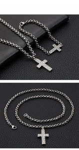 Macro shot of retro stainless steel cross pendant and chain with textured surface detail