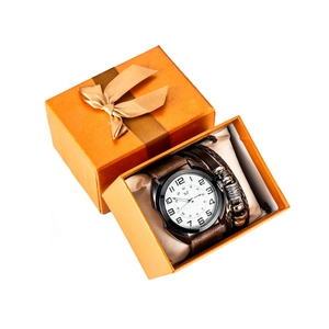 Close-up of men's quartz watch and braided leather bracelet in an orange gift box