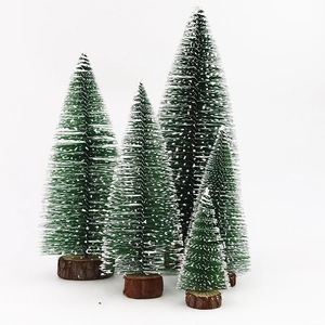 Five mini green cedar Christmas trees with snow effect and round wooden bases on white background