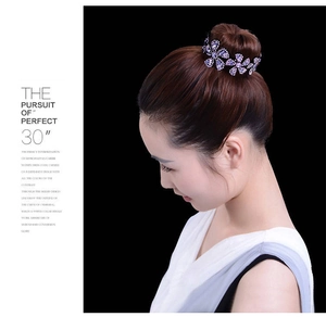 Detail view of a purple rhinestone flower hair bun maker on elegant hairstyle