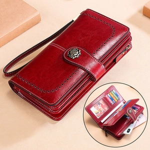 Detail view of red leather wallet with floral metal clasp and internal RFID card slots