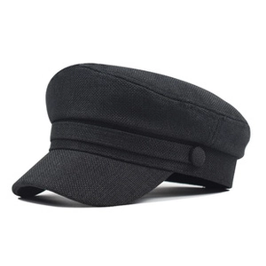 Close-up profile of a black PU leather newsboy cap featuring side metal button details