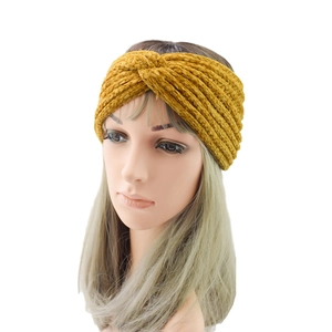 Knitted mustard yellow cross twist headband with vertical ribbed texture for women
