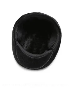 Detail of the winter flat cap showing the thick black faux fur lining for warmth