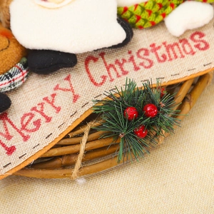 Christmas wreath featuring Merry Christmas burlap, pine needles, berries, and cartoon dolls