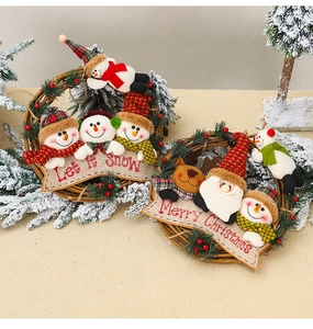 Detail of Christmas wreath hangings with Santa, snowman, and reindeer on natural rattan