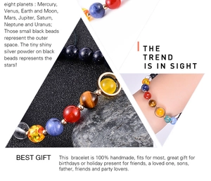 Macro detail of natural stone galaxy bracelet showing eight planets and matte black beads