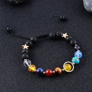 Macro shot of 8mm planet bracelet with colorful natural stones and black lava rock details