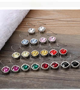 Macro view of square cut zircon earrings in diverse colors with metal hooks