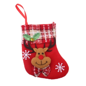 Detail of red Christmas stocking featuring reindeer decor, bells, and hanging loop
