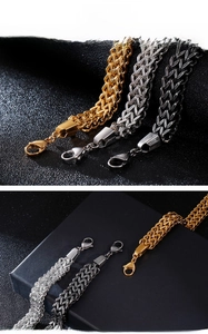 Close-up of dual-layer stainless steel V-link chains with robust lobster clasp detail