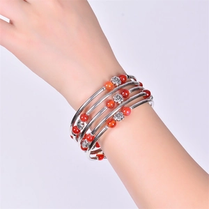 Detail of multi-layer beaded bracelet with red agate, silver tubes, and rose beads