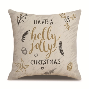 Close-up of linen Christmas pillowcase with holly jolly text and pine branch graphics