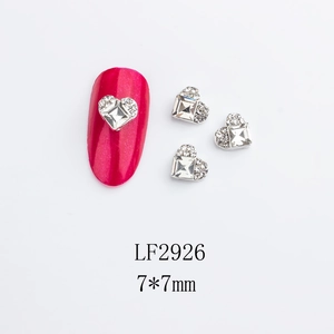Close-up of 7x7mm heart-shaped alloy nail rhinestones with silver metal base detail