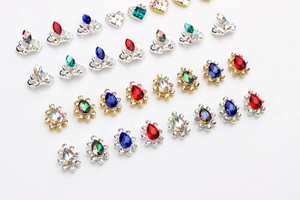 Macro shot of assorted alloy nail art charms with colorful K9 rhinestones and crystals