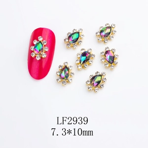 Macro detail of K9 crystal crown nail charms and size specifications for manicures