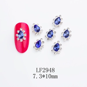 Macro detail of 7.3x10mm crown-shaped nail art rhinestones with teardrop blue sapphire glass