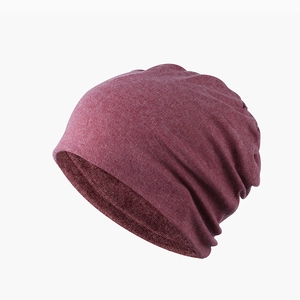 Detail view of the soft burgundy beanie hat fabric texture with natural stylish folds