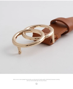 Detail shot of a brown slim leather belt featuring a classic golden double ring buckle