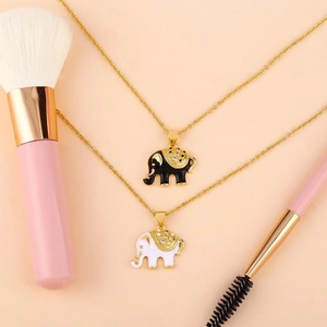 Chic elephant pendants in black and white enamel with gold plating and sparkling crystals