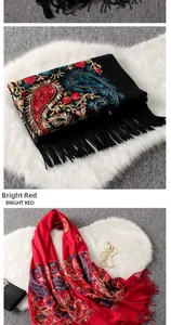 Detail of vibrant paisley embroidery and tassel trim on thick cashmere cotton scarves