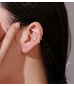 Detail of double-layer gold ear cuff with shimmering micro-pave cubic zirconia stones