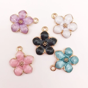 Detailed view of colorful cherry blossom alloy pendants with gold trim for DIY jewelry