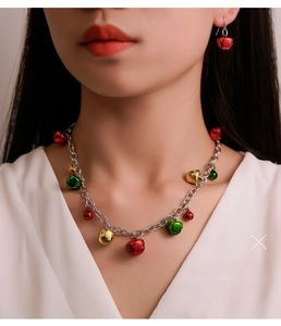 Detail of colorful bell necklace and earring set worn by a model for Christmas