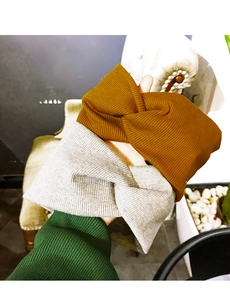 Detail showing the thick ribbed knit texture and cross knot design of these headbands