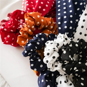 Detailed pile of assorted polka dot hair scrunchies in various vibrant colors
