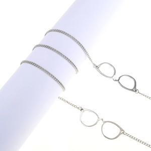Silver metal eyewear chain featuring decorative eyeglass frame pendants on cross chain