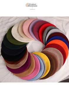 Over twenty colorful wool felt berets for women arranged in a circular gradient layout