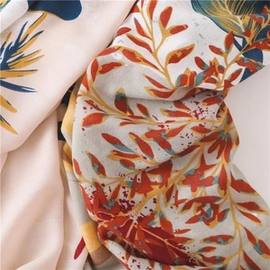 Detailed macro view of linen cotton fabric featuring colorful floral plant patterns