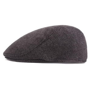 Side view of dark grey herringbone beret showing detailed wool texture and flat cap style