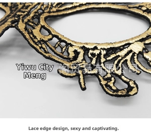 Macro detail of black and gold lace mask featuring intricate gilded floral patterns