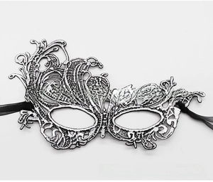 Detailed view of silver lace masquerade mask with intricate hollow patterns and black ribbons