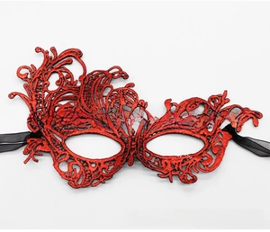 Close-up of red lace masquerade mask with intricate floral embroidery and black chiffon ties