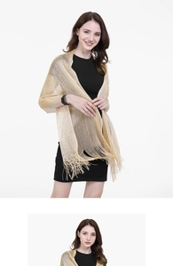 Detailed view of elegant golden scarf featuring high-quality fringe and lustrous fabric