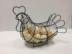 Black iron wire chicken-shaped egg basket filled with white eggs in a kitchen setting