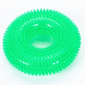 Close-up of green spiked TPR dog toy ring with textured surface for dental cleaning
