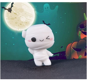 Close-up of a cute mini white mummy figurine with a festive Halloween moon background